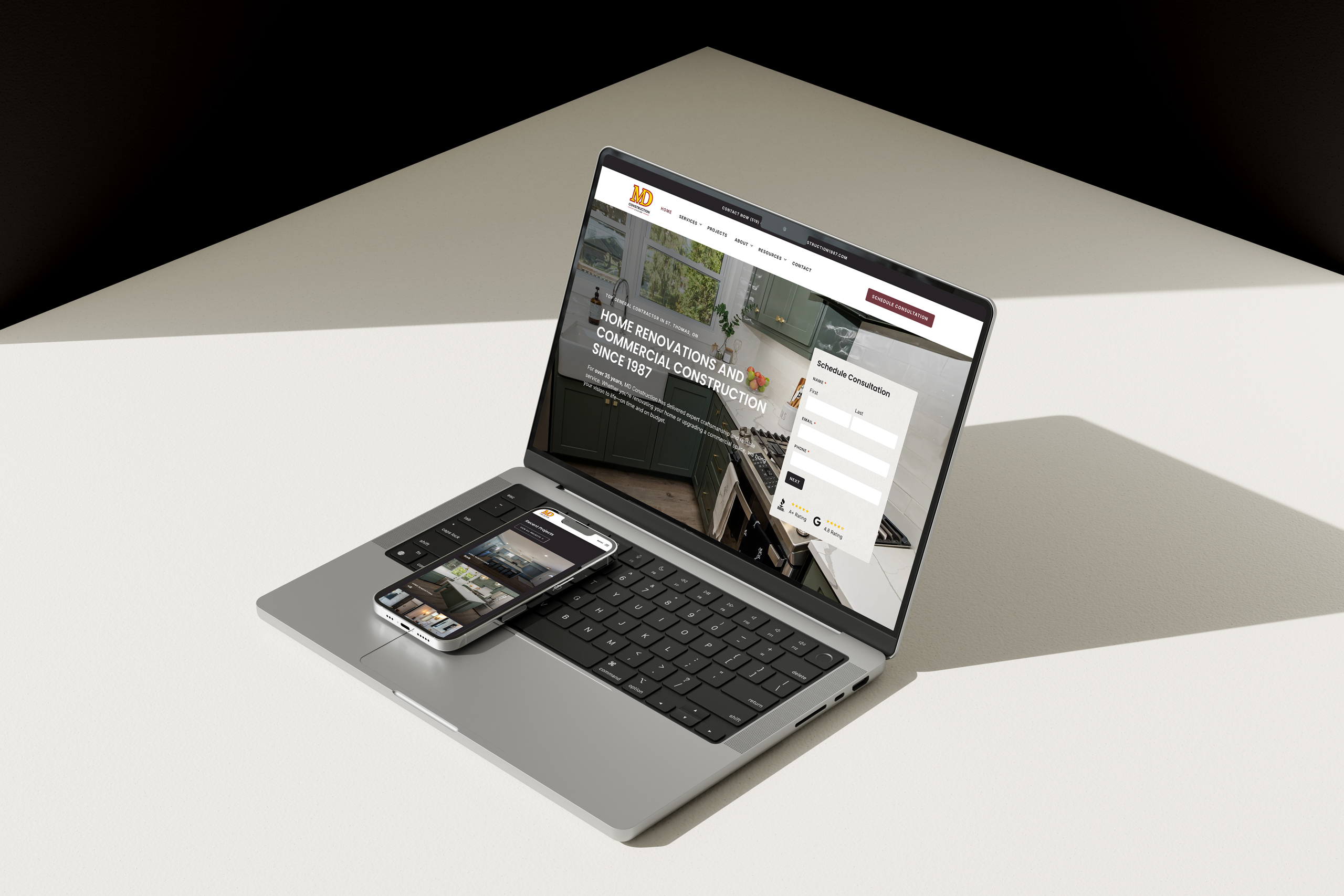 Laptop and smartphone displaying the MD Construction website design — created by Tweakable for home service businesses.